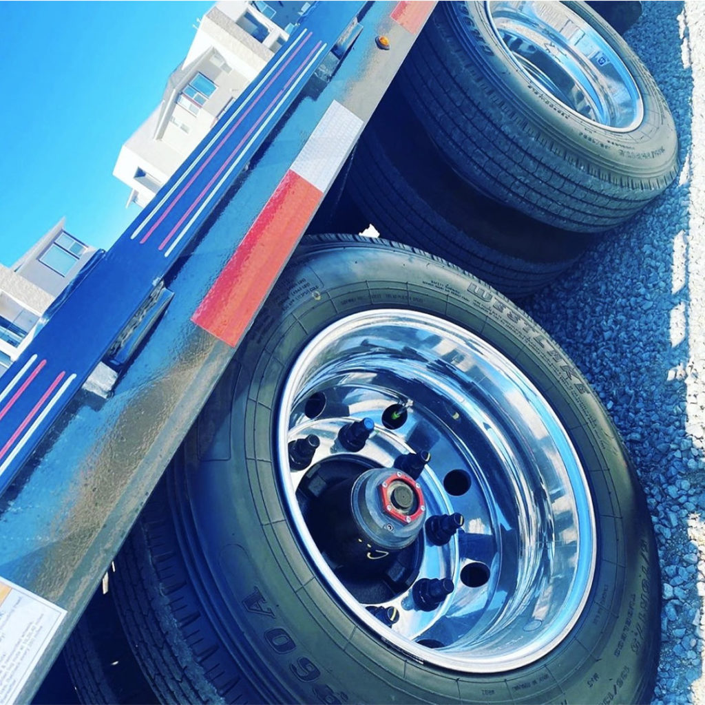 aluminum wheels and Valcrum caps on a dually trailer