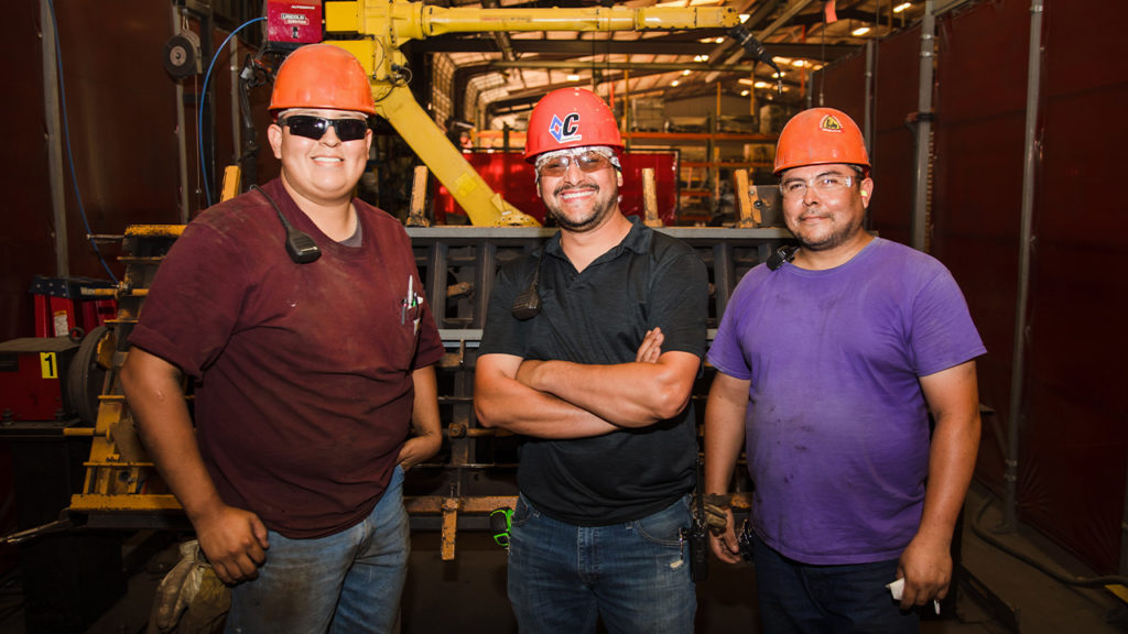 Employees wearing hard hats while working