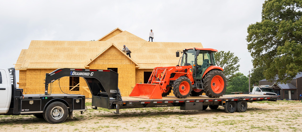 Model FMAX207 Fleetneck Engineered Beam Gooseneck Trailer at house construction site