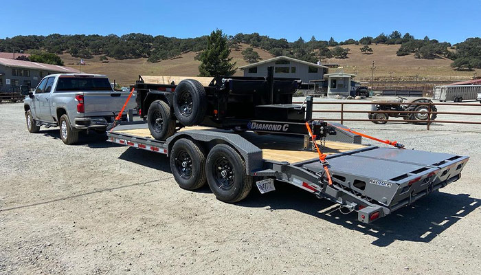 A Diamond C trailer loading another Diamond C trailer at 101 Trailer Sales