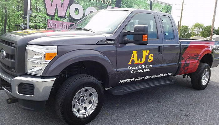 AJ's Truck and Trailer Center logo on a truck