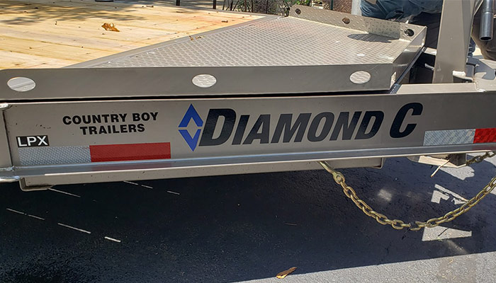 Country Boy Trailer logo with the Diamond C Trailers logo.