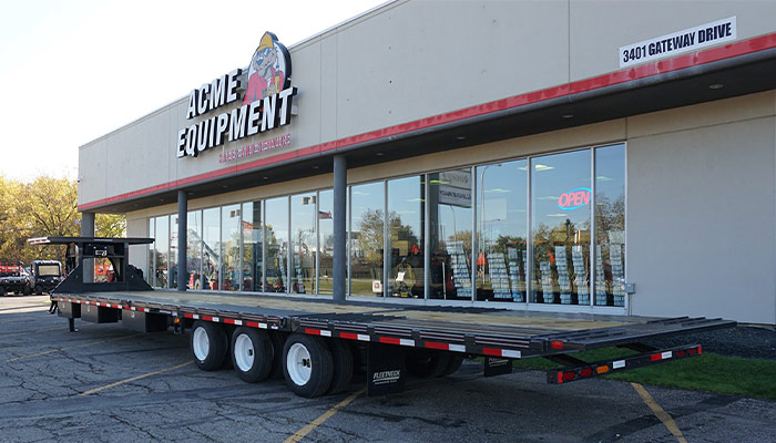 A Diamond C Fleetneck trailer in front of ACME Equipment Grand Fork.