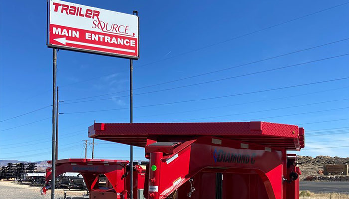 Diamond C Red Trailer in front of the Trailer Source Sign