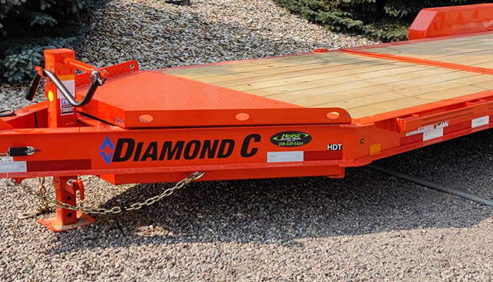 A Diamond C trailer with the Diamond C logo and the Holst Trailer Sales logo.