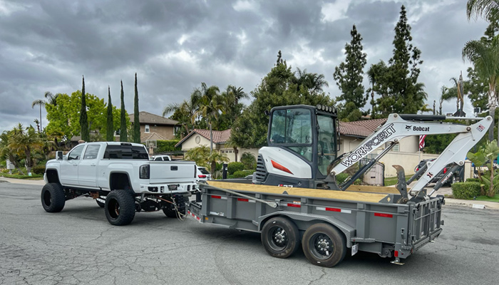 WORKFORIT Apparel's Ryan Fusco with his favorite Diamond C dump trailer.